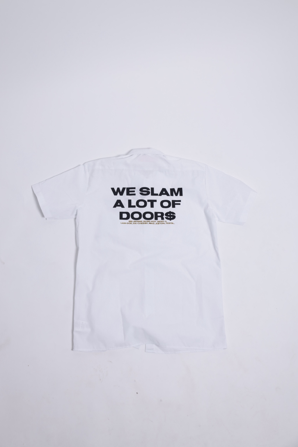White garment with We Slam a Lot of Doors graphic photographed in studio