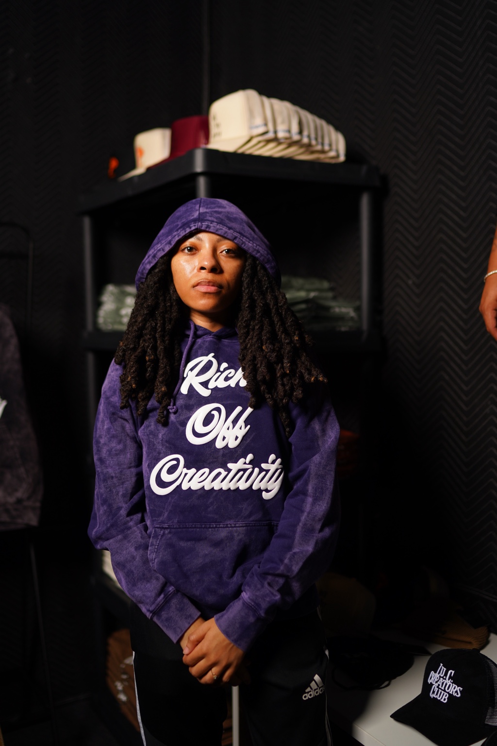 Woman wearing the purple wash Rich Off Creativity hoodie