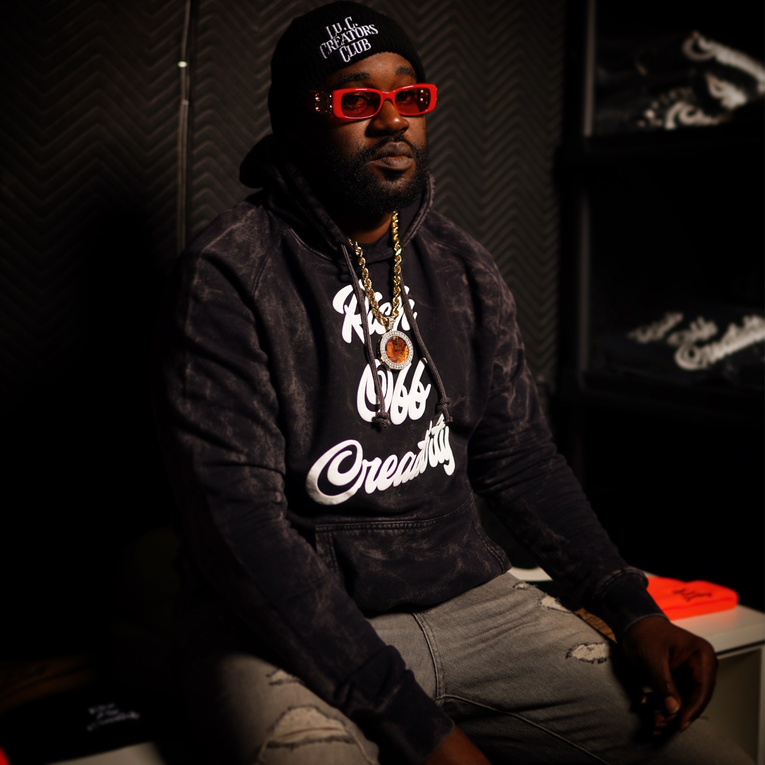 Man wearing the washed black Rich Off Creativity hoodie and Lu.C. Creators Club beanie